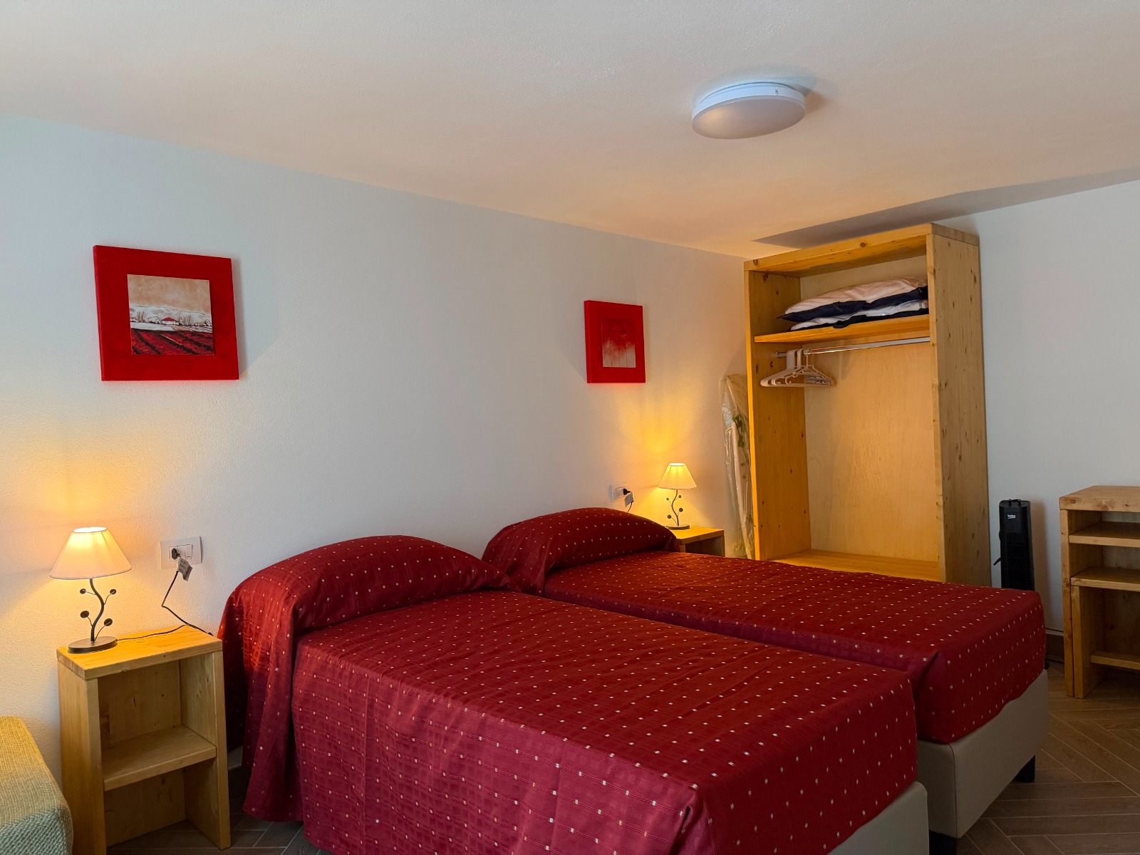 Camera da letto con due letti e arredi in legno